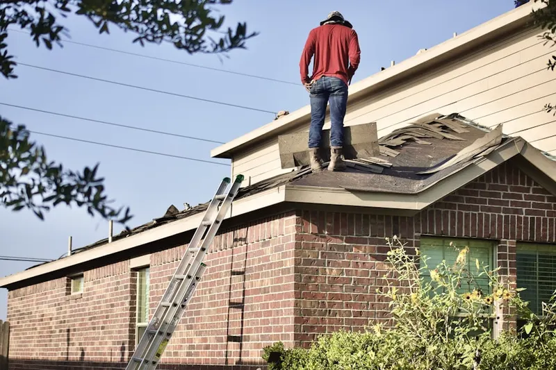 Professional roofer working on a residential roof in Pine Island